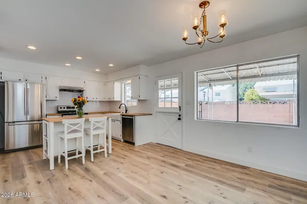 a kitchen with stainless steel appliances granite countertop a refrigerator and microwave