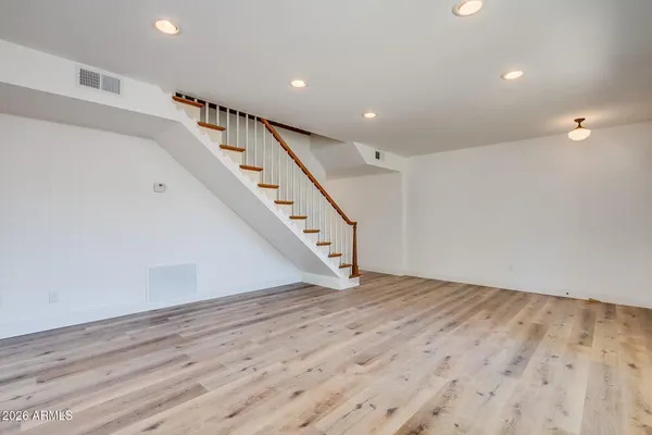 a view of an empty room with wooden floor