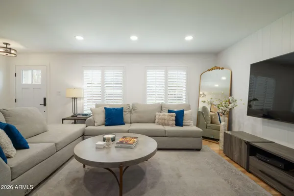 a living room with furniture a fireplace and a flat screen tv