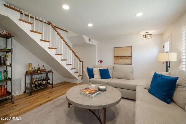 a living room with furniture and a wooden floor