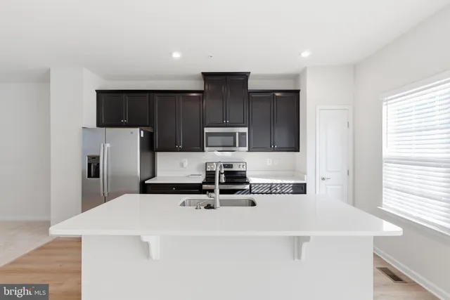a kitchen with a sink a stove and refrigerator