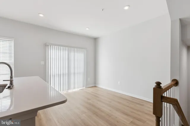 a view of a room with wooden floor and furniture