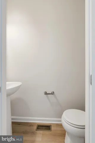 a white toilet sitting next to a shower