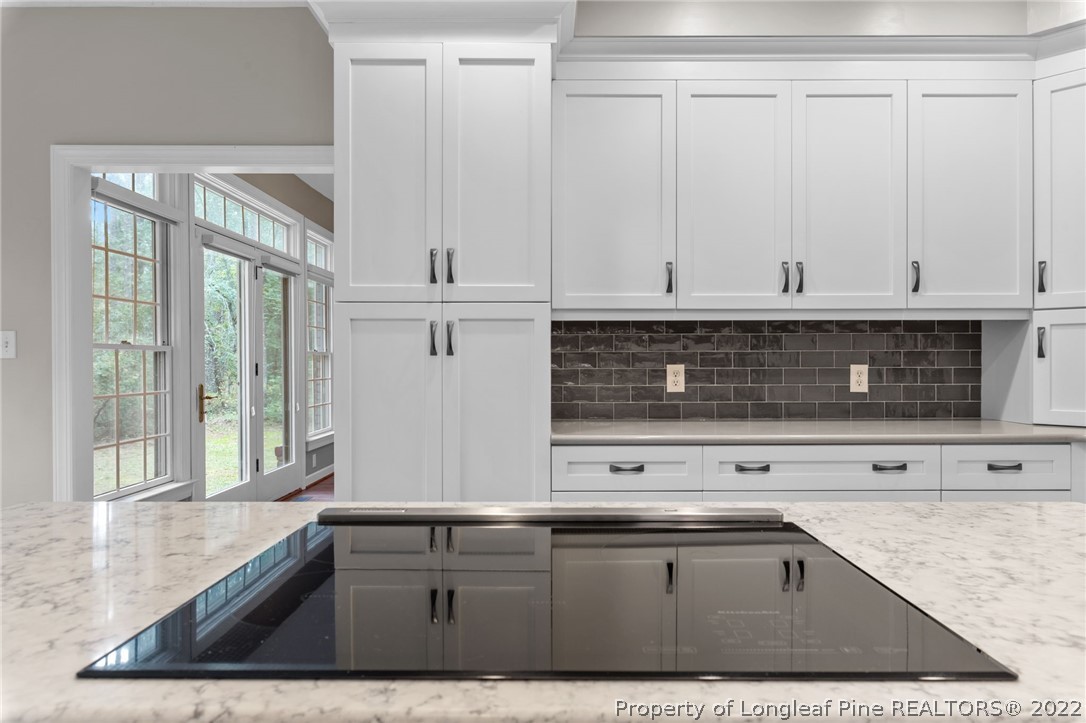 30481 East Lake Road Wagram, NC 28396 - Photo 11 of 25 a view of kitchen with granite countertop a sink white cabinets and white appliances