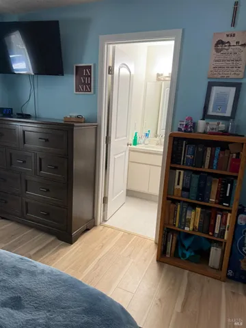 a room with a bed and a book shelf
