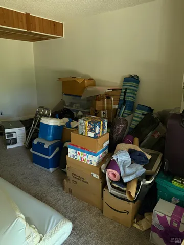 a living room with furniture and a air conditioner vent