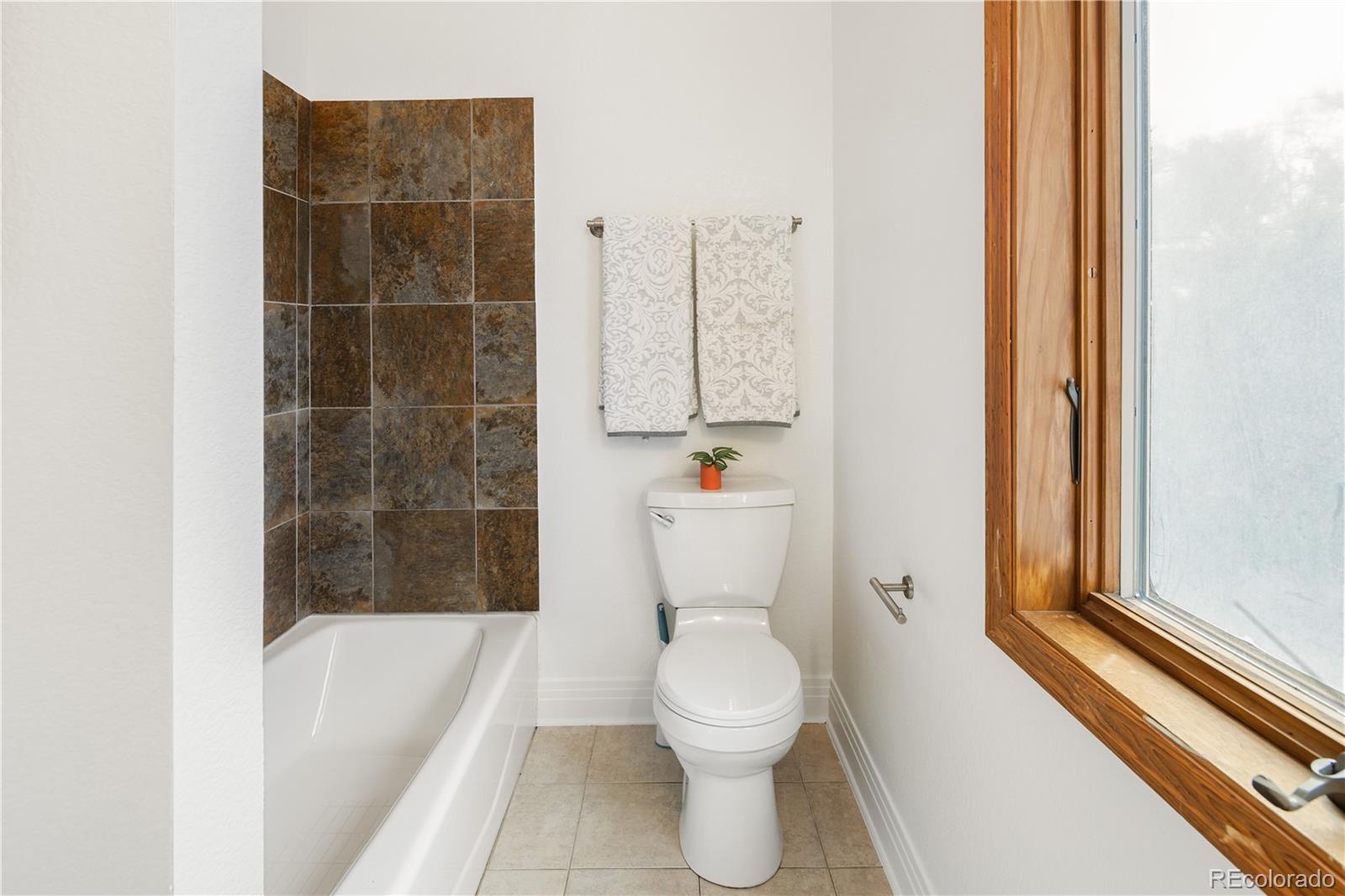 380 County Road Louisville, CO 80027 - Photo 22 of 42 a bathroom with a toilet and a bathtub