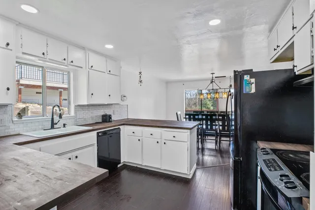 a kitchen with granite countertop a sink stove and cabinets