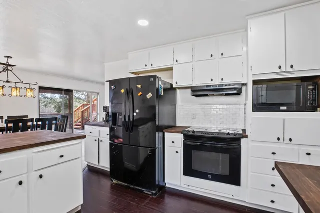a kitchen with stainless steel appliances a stove microwave and cabinets