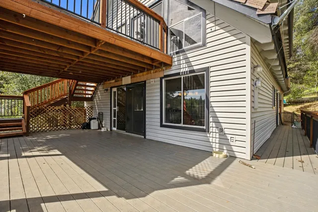 a view of backyard with a deck and wooden floor