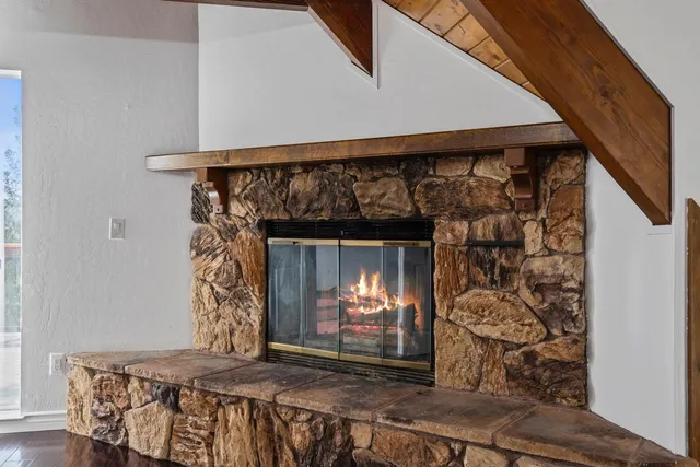 a view of fireplace with wooden floor