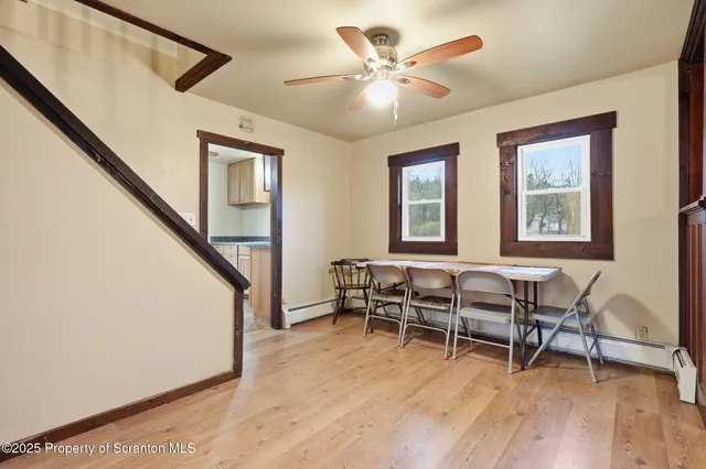 a view of a dining room with furniture window and wooden floor