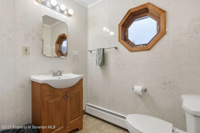 a bedroom with bed and a potted plant