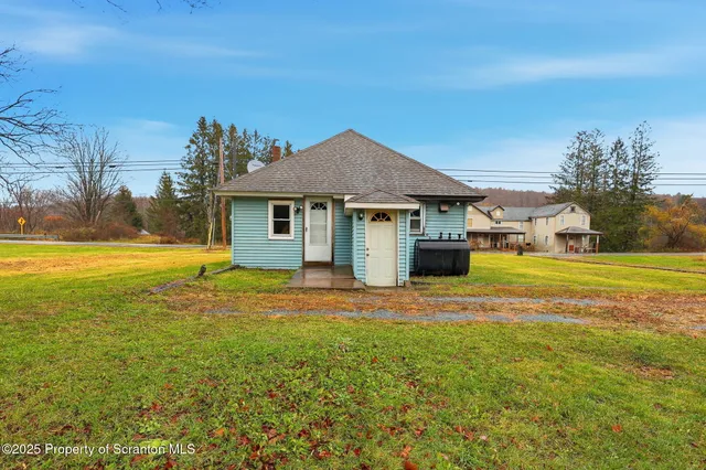 a house view with swimming pool in front of it