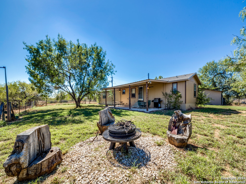 6472 Bluntzer Road Jourdanton, TX 78026 - Photo 28 of 45 a front view of a house with garden