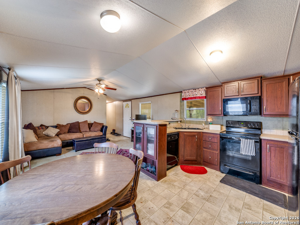 6472 Bluntzer Road Jourdanton, TX 78026 - Photo 30 of 45 a living room with furniture kitchen view and a table