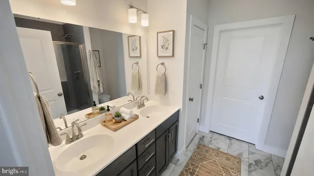 a en suite bathroom with a double vanity sink mirror and double