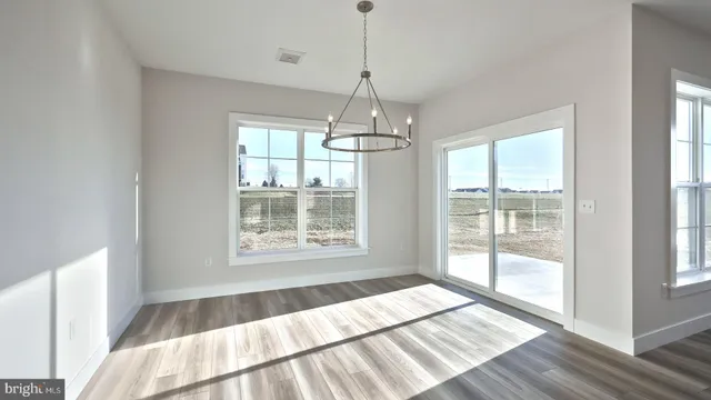 a view of walk in closet with wooden floor