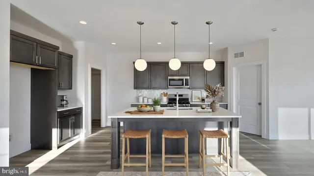 a kitchen with a dining table chairs sink and cabinets