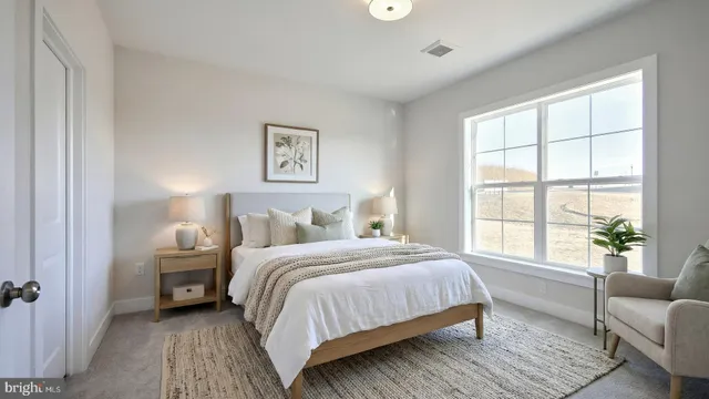 a bedroom with a bed and a couch