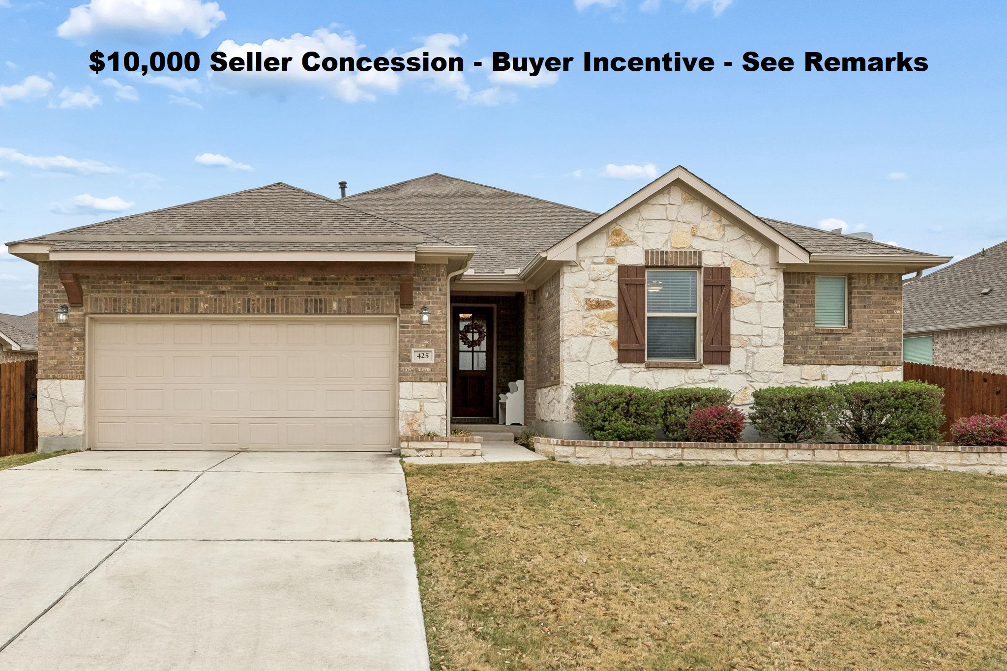 425 Windom Way Georgetown, TX 78626 - Photo 1 of 38 Ranch-style home with stone siding, an attached garage, driveway, a shingled roof, and brick siding