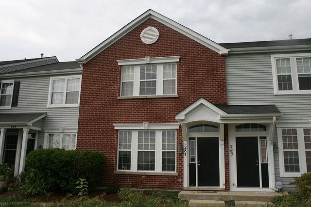 287 Springbrook Trail South Oswego, IL 60543 - Photo 1 of 14 a front view of a house with a yard