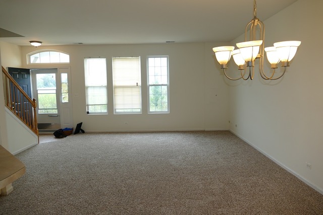 287 Springbrook Trail South Oswego, IL 60543 - Photo 2 of 14 a view of a room with windows and chandelier