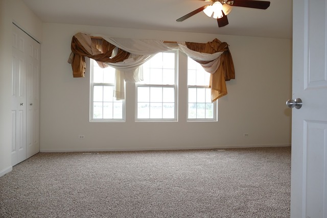 287 Springbrook Trail South Oswego, IL 60543 - Photo 5 of 14 an empty room with a window
