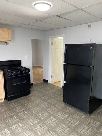 a kitchen with stainless steel appliances granite countertop a stove a sink and a white cabinets