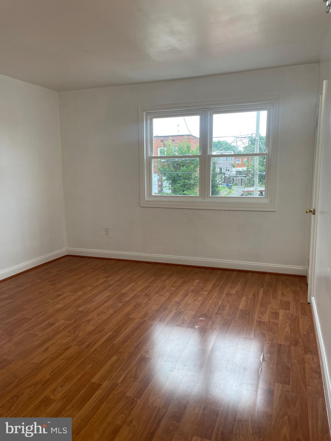 2206 15th Street Northeast Washington, DC 20018 - Photo 7 of 11 an empty room with wooden floor and windows
