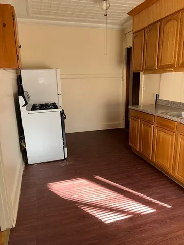 a view of storage and utility room with wooden floor