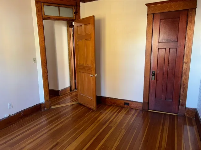 a view of a room with wooden floor and brick walls