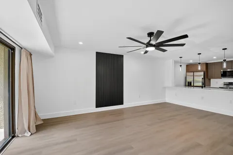 a view of an empty room with a ceiling fan