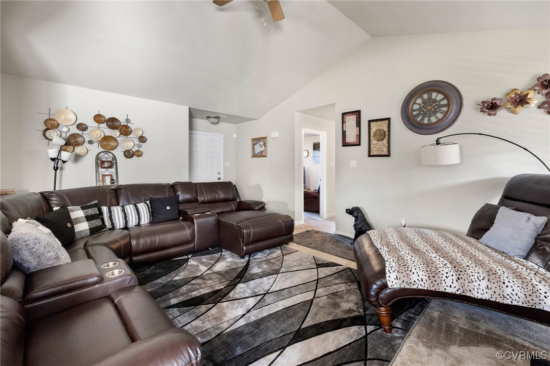 Living room featuring ceiling fan and lofted ceili