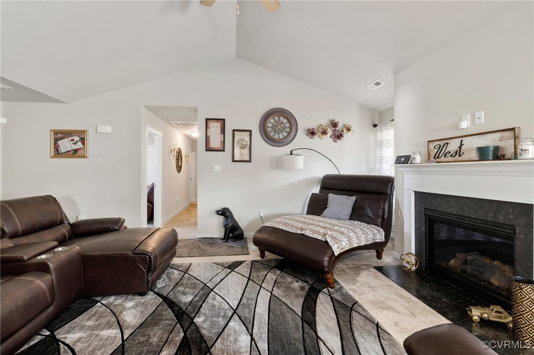 Living room with vaulted ceiling and ceiling fan