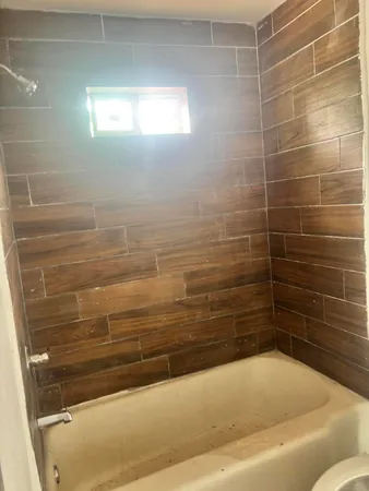 a bathroom with a toilet and a bathtub