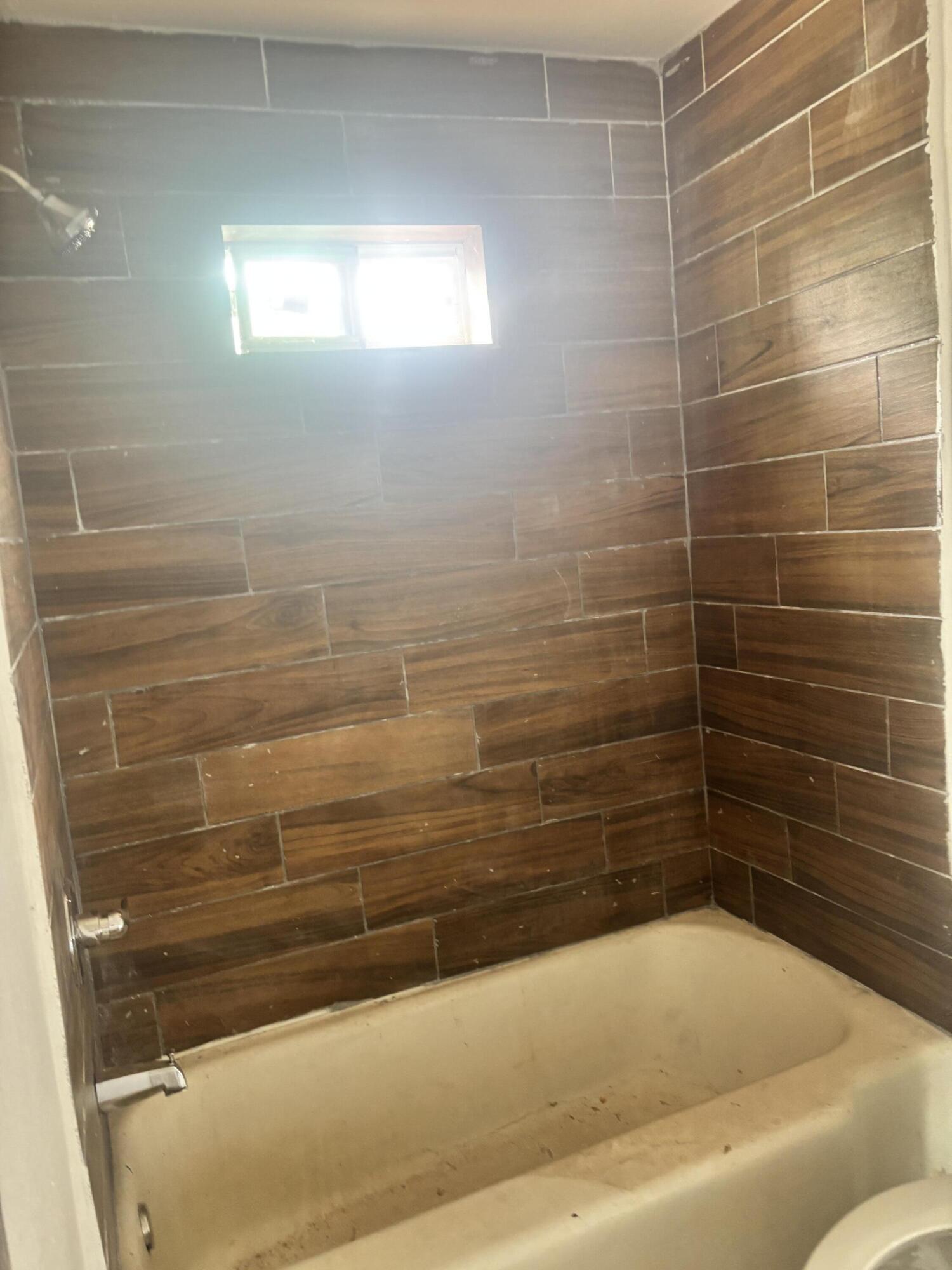 312 East 34th Street Lubbock, TX 79404 - Photo 13 of 25 a bathroom with a bathtub