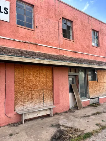 a front view of a building with a yard