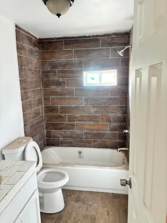 a bathroom with a toilet and a bathtub