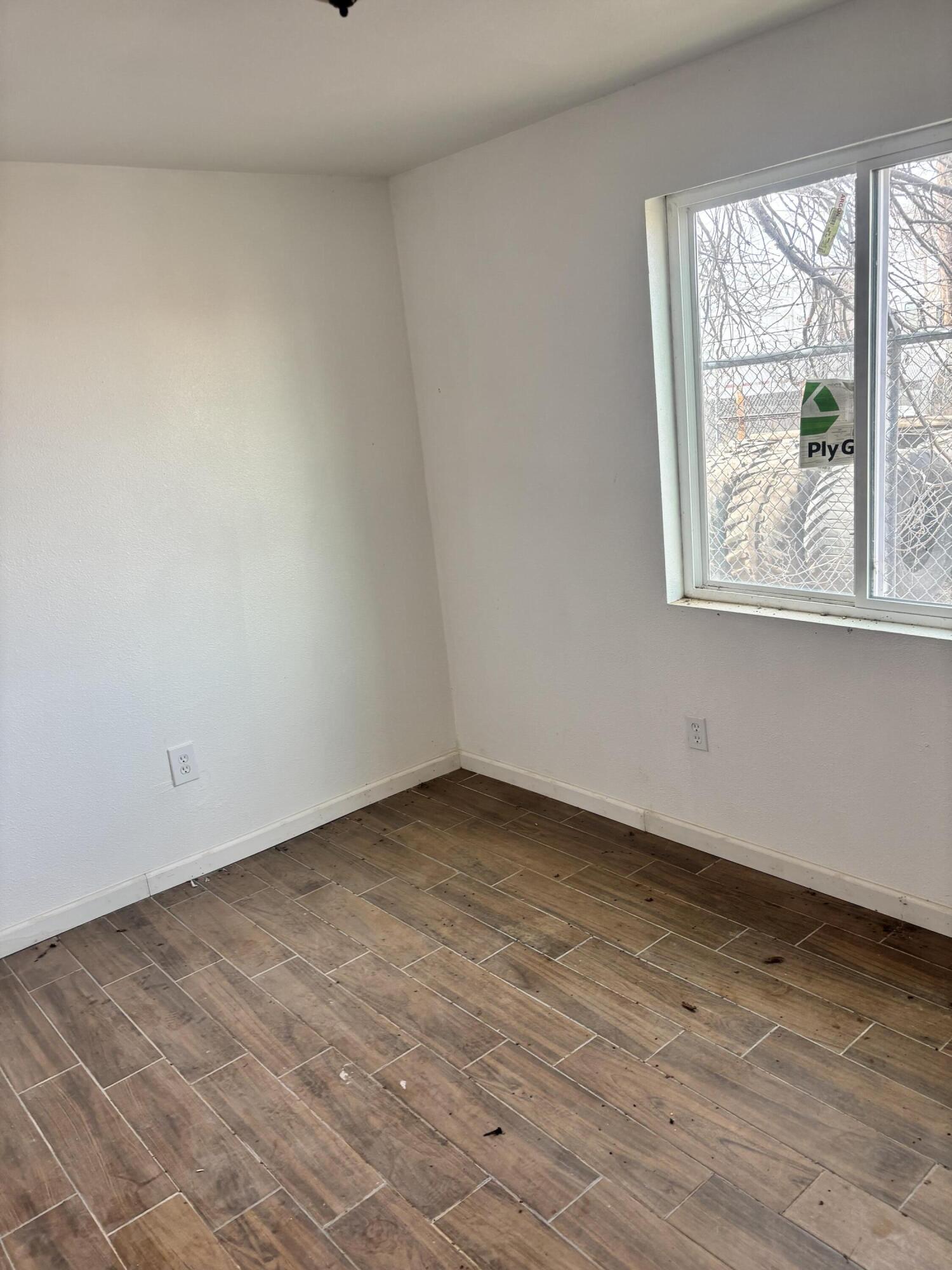 312 East 34th Street Lubbock, TX 79404 - Photo 9 of 25 wooden floor in an empty room with a window