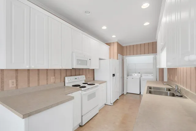 a kitchen with stainless steel appliances a refrigerator sink and cabinets