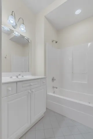 a bathroom with a bathtub a sink and a mirror