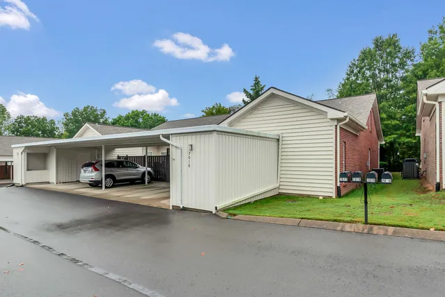 a view of a house with a yard and garage