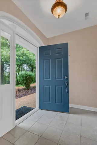 an empty room with windows and view of balcony
