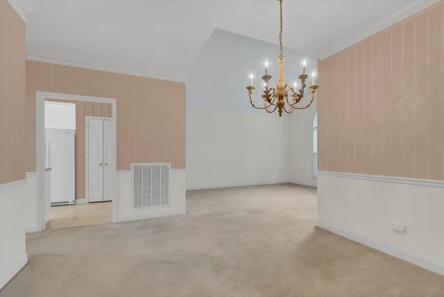 a view of a chandelier in big room and chandelier