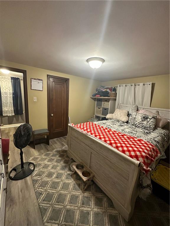 8585 Peebles Road Pittsburgh, PA 15237 - Photo 14 of 23 a bedroom with a bed a mirror and lamp