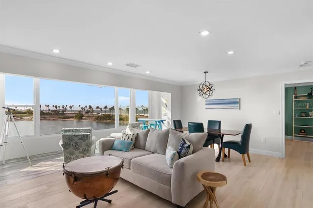 a living room with furniture and a view of kitchen