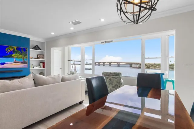 a living room with furniture and a view of kitchen