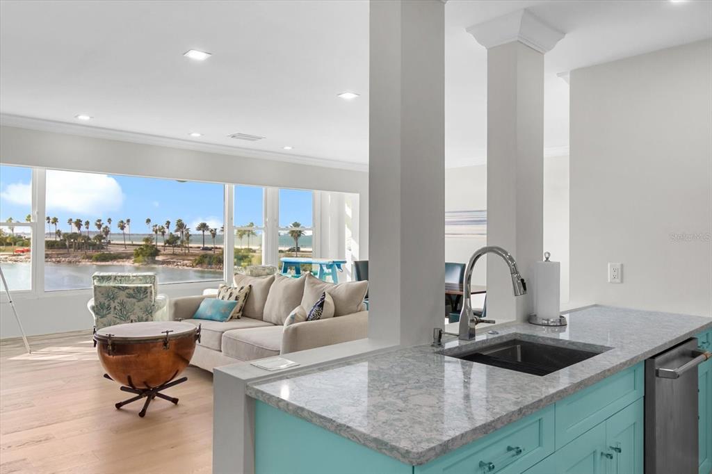 174 Golden Gate Point, Unit 32 Sarasota, FL 34236 - Photo 24 of 46 a living room with kitchen island furniture and a sink