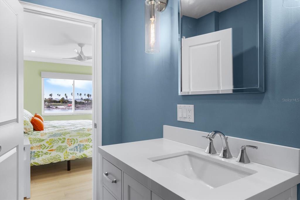 174 Golden Gate Point, Unit 32 Sarasota, FL 34236 - Photo 32 of 46 a bathroom with a sink vanity and mirror